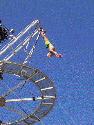Tina hangs by her toes as she rotates around the disk.