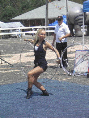 Miss Ashley Winn performs with a single silver hula hoop