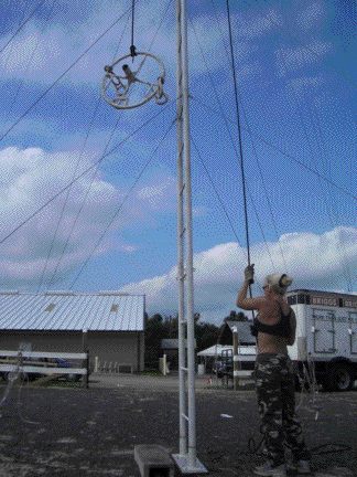 Tina hoists the Aerial Space Platform up to John to be assembled to the sway pole