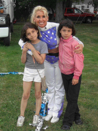 Galaxy Girl gives two of her young fans a hug